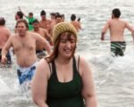 Participants taking the plunge into icy waters during the Polar Bear Club Swim