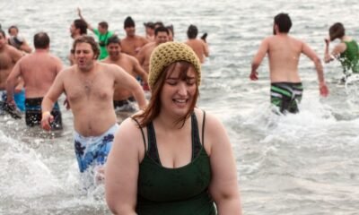 Participants taking the plunge into icy waters during the Polar Bear Club Swim