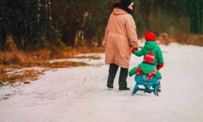 8-year-old-girl-helping-elderly-woman-in-snow