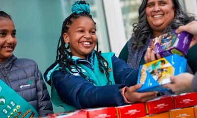 Girl Scout cookie sale stand with young girls selling cookies