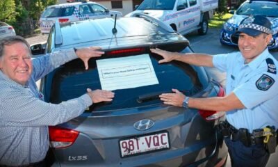 Students painting messages on sheriff patrol cars