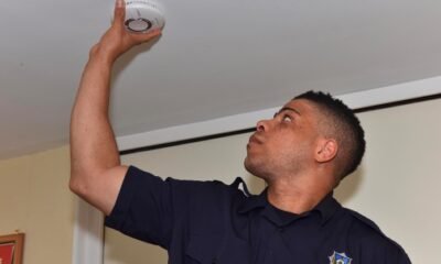 Firefighter installing smoke detector