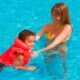 child swim lesson pool red cross life jacket