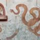 Pompeii lararium mural snakes peacock Anubis Roman shrine volcanic ash preservation