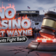 ˇA viral, hyper-realistic YouTube thumbnail with a dramatic political atmosphere. The background is the packed entrance of Memorial Coliseum at dusk with hundreds of angry residents holding signs under harsh stadium floodlights and a stormy Indiana sky. The composition uses a low-angle shot to focus on the main subject: a massive cracked concrete gavel slamming down onto a glowing red casino chip. The image features massive 3D typography with strict hierarchy: The Primary Text reads exactly: 'NO CASINO FORT WAYNE'. This text is massive, the largest element in the frame, rendered in burning chrome with red molten edges like a high-budget 3D render. The Secondary Text reads exactly: 'Residents Fight Back'. This text is significantly smaller, positioned below the main text with a thick white outline and black sticker border to contrast against the dramatic sky. 8k, Unreal Engine 5, cinematic render
