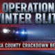 A viral, hyper-realistic YouTube thumbnail with a tense law-enforcement atmosphere. The background is a dark snow-dusted Mesa County highway at night lit by red and blue emergency lights cutting through falling snow and fog. The composition uses a dramatic low-angle shot to focus on the main subject: a gleaming Colorado State Patrol cruiser with activated light bar dominating the foreground. The image features massive 3D typography with strict hierarchy: The Primary Text reads exactly: 'OPERATION WINTER BLITZ'. This text is massive, the largest element in the frame, rendered in cold chrome metal with glowing blue edge lighting to look like a high-budget 3D render. The Secondary Text reads exactly: 'MESA COUNTY CRACKDOWN BEGINS'. This text is significantly smaller, positioned below the main text. It features a thick, pulsing red outline border to contrast against the dark background. Make sure text 2 is always different theme, style, effect and border compared to text 1. The text materials correspond to the story's concept. Crucial Instruction: There is absolutely NO other text, numbers, watermarks, or subtitles in this image other than these two specific lines. 8k, Unreal Engine 5, cinematic render