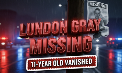 A viral, hyper-realistic YouTube thumbnail with a tense, urgent crime-alert atmosphere. The background is a dark rainy Fort Wayne street at night with red and blue police light reflections glistening on wet pavement and blurred emergency vehicles in the distance. The composition uses a dramatic low-angle shot to focus on the main subject: a torn missing person poster of a child fluttering on a telephone pole in the wind. The image features massive 3D typography with strict hierarchy: The Primary Text reads exactly: 'LUNDON GRAY MISSING'. This text is massive, the largest element in the frame, rendered in glowing crimson red chrome with emergency light reflections to look like a high-budget 3D render. The Secondary Text reads exactly: '11-YEAR-OLD VANISHED'. This text is significantly smaller, positioned below the main text with a thick white border and pulsing red outline sticker style to contrast against the dark background. The text materials correspond to the story's concept. Crucial Instruction: There is absolutely NO other text, numbers, watermarks, or subtitles in this image other than these two specific lines. 8k, Unreal Engine 5, cinematic render