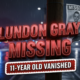 A viral, hyper-realistic YouTube thumbnail with a tense, urgent crime-alert atmosphere. The background is a dark rainy Fort Wayne street at night with red and blue police light reflections glistening on wet pavement and blurred emergency vehicles in the distance. The composition uses a dramatic low-angle shot to focus on the main subject: a torn missing person poster of a child fluttering on a telephone pole in the wind. The image features massive 3D typography with strict hierarchy: The Primary Text reads exactly: 'LUNDON GRAY MISSING'. This text is massive, the largest element in the frame, rendered in glowing crimson red chrome with emergency light reflections to look like a high-budget 3D render. The Secondary Text reads exactly: '11-YEAR-OLD VANISHED'. This text is significantly smaller, positioned below the main text with a thick white border and pulsing red outline sticker style to contrast against the dark background. The text materials correspond to the story's concept. Crucial Instruction: There is absolutely NO other text, numbers, watermarks, or subtitles in this image other than these two specific lines. 8k, Unreal Engine 5, cinematic render