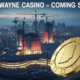 A viral, hyper-realistic YouTube thumbnail with a dramatic casino/gambling atmosphere. The background is a moody nighttime Fort Wayne skyline with I-69 highway lights streaking below and massive casino resort construction cranes rising. Warm neon reds and golds mix with cold Indiana winter blues. The composition uses a dramatic low-angle shot looking up for power and scale. The main subject is a huge, gleaming golden casino chip floating in the foreground with Indiana state outline engraved on it. The image features massive 3D typography with strict hierarchy: The Primary Text reads exactly: 'FORT WAYNE CASINO'. This text is massive, rendered in glowing chrome with red neon edge lighting like high-end Vegas signage. The Secondary Text reads exactly: 'COMING SOON?'. This text is smaller, positioned below with thick white outline and red drop shadow sticker style. Crucial Instruction: There is absolutely NO other text, numbers, watermarks, or subtitles in this image other than these two specific lines. 8k, Unreal Engine 5, cinematic render.