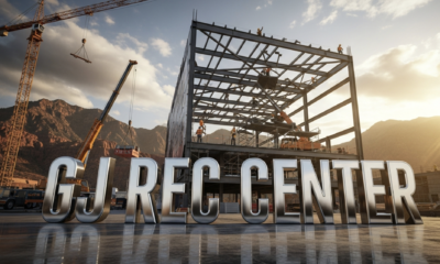 A viral, hyper-realistic YouTube thumbnail with a bold, energetic construction site atmosphere. The background is a massive active job site at golden hour with Grand Junction red rock mountains behind, cranes lifting steel beams, workers in hard hats, warm dramatic sunlight cutting through dust clouds. The composition uses a dramatic low-angle shot looking up to emphasize scale and power on the main subject: a huge gleaming steel framework of the future recreation center rising from the ground. The image features massive 3D typography with strict hierarchy: The Primary Text reads exactly: 'GJ REC CENTER'. This text is massive, the largest element in the frame, rendered in polished chrome with realistic reflections and edge glow to look like a high-budget 3D render. The Secondary Text reads exactly: 'OPENING 2026'. This text is significantly smaller, positioned below the main text with thick orange outline and subtle motion blur effect to contrast against the sky. The text materials correspond to the story's concept. Crucial Instruction: There is absolutely NO other text, numbers, watermarks, or subtitles in this image other than these two specific lines. 8k, Unreal Engine 5, cinematic render.