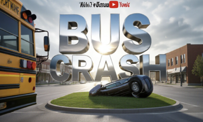 A viral, hyper-realistic YouTube thumbnail with a Kinetic News atmosphere. The background is a detailed Fort Wayne street intersection with morning sunlight breaking through overcast clouds. The composition uses a Low Angle to focus on the main subject: a yellow school bus bumper visible on the side and a dramatic overturned sedan in a grassy median. The image features massive 3D typography with strict hierarchy: The Primary Text reads exactly: 'BUS CRASH'. This text is massive, the largest element in the frame, rendered in Chrome Red to look like a high-budget 3D render. The Secondary Text reads exactly: 'CAR FLIPS'. This text is significantly smaller, positioned below or next to the main text. It features a thick, distinct yellow border/outline to contrast against the background. Make sure text 2 is always different theme, style, effect and border compared to text 1.