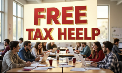 A viral, hyper-realistic YouTube thumbnail with a warm, helpful community atmosphere. The background is a busy Colorado Mesa University computer lab filled with smiling students helping families at tables covered with tax forms and laptops, soft natural window light pouring in. The composition uses a slight low angle to focus on the main subject: a large, open IRS refund check made of glowing white paper floating above the scene. The image features massive 3D typography with strict hierarchy: The Primary Text reads exactly: 'FREE TAX HELP'. This text is massive, the largest element in the frame, rendered in bold crimson and gold with a metallic shine to match CMU colors. The Secondary Text reads exactly: 'Up to $8,700 Back'. This text is significantly smaller, positioned below the main text with a thick white sticker-style outline and red border to pop against the background. The text materials correspond to the story's concept. Crucial Instruction: There is absolutely NO other text, numbers, watermarks, or subtitles in this image other than these two specific lines. 8k, Unreal Engine 5, cinematic render