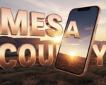 A viral, hyper-realistic YouTube thumbnail with a hopeful, warm Western Colorado sunrise atmosphere. The background is a sweeping Grand Junction landscape with the Book Cliffs glowing in golden morning light and subtle lens flare. The composition uses a dramatic low angle to focus on the main subject: a glowing, three-dimensional smartphone floating in mid-air, screen facing camera. The image features massive 3D typography with strict hierarchy: The Primary Text reads exactly: 'MESA COUNTY'. This text is massive, the largest element in the frame, rendered in polished rose-gold chrome with subtle Colorado red rock texture to look like a high-budget 3D render. The Secondary Text reads exactly: 'FIXES MENTAL HEALTH'. This text is significantly smaller, positioned below the main text with thick white outline and soft blue glow border to pop against the sunrise sky. Make sure text 2 is always different theme, style, effect and border compared to text 1. The text materials correspond to the story's concept. Crucial Instruction: There is absolutely NO other text, numbers, watermarks, or subtitles in this image other than these two specific lines. 8k, Unreal Engine 5, cinematic render