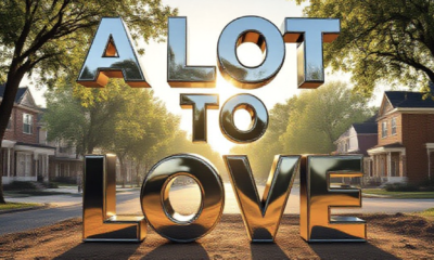 A viral, hyper-realistic YouTube thumbnail with a gritty urban-renewal atmosphere. The background is a tree-lined Fort Wayne street at golden hour with vacant lots transforming into brand-new affordable homes under construction, warm sunlight cutting through mature oaks. The composition uses a dramatic low-angle shot to focus on the main subject: a gleaming oversized house key made of polished chrome floating above a dirt lot with fresh foundation poured. The image features massive 3D typography with strict hierarchy: The Primary Text reads exactly: 'A LOT TO LOVE'. This text is massive, the largest element in the frame, rendered in shiny chrome with realistic reflections to look like a high-budget 3D render. The Secondary Text reads exactly: 'PHASE 2 NOW OPEN'. This text is significantly smaller, positioned below the main text with a bold red sticker-style outline and slight drop shadow to pop against the sky. The text materials correspond to the story's concept. Crucial Instruction: There is absolutely NO other text, numbers, watermarks, or subtitles in this image other than these two specific lines. 8k, Unreal Engine 5, cinematic render
