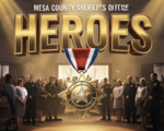 A viral, hyper-realistic YouTube thumbnail with a dramatic cinematic atmosphere. The background is the packed Mesa County Sheriff's Office community room filled with warm spotlight beams cutting through light haze and proud families standing. The composition uses a powerful low-angle shot to focus on the main subject: a gleaming gold Medal of Valor and Distinguished Service medal hanging in mid-air as if just pinned. The image features massive 3D typography with strict hierarchy: The Primary Text reads exactly: 'HEROES'. This text is massive, the largest element in the frame, rendered in molten gold chrome with dramatic rim lighting to look like a high-budget 3D render. The Secondary Text reads exactly: 'SAVED LIVES'. This text is significantly smaller, positioned below the main text with a thick red-white-blue patriotic outline border in sticker style to contrast against the background. Make sure text 2 is always different theme, style, effect and border compared to text 1. The text materials correspond to the story's concept. Crucial Instruction: There is absolutely NO other text, numbers, watermarks, or subtitles in this image other than these two specific lines. 8k, Unreal Engine 5, cinematic render