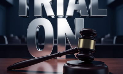 A viral, hyper-realistic YouTube thumbnail with a Crime/Legal atmosphere. The background is a blurred, high-contrast interior of a modern courtroom with dramatic shadows. The composition uses a Low Angle to focus on the main subject: a detailed 3D Gavel resting on a wooden surface. The image features massive 3D typography with strict hierarchy: The Primary Text reads exactly: 'TRIAL ON'. This text is massive, the largest element in the frame, rendered in Chrome to look like a high-budget 3D render. The Secondary Text reads exactly: 'COMPETENCY RULED'. This text is significantly smaller, positioned below or next to the main text. It features a thick, distinct color border/outline (sticker style) to contrast against the background. Make sure text 2 is always different theme, style, effect and border compared to text 1.