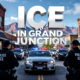 A viral, hyper-realistic YouTube thumbnail with a tense urban law-enforcement atmosphere. The background is downtown Grand Junction Colorado at late morning with clear blue sky and red rock mountains faintly visible, busy small-city street with parked cars and storefronts. The composition uses a dramatic low-angle shot looking up at multiple black tactical vests that read POLICE ICE in large white letters surrounding a silver sedan pulled to the curb with unmarked SUVs behind it flashing red-blue lights. The image features massive 3D typography with strict hierarchy: The Primary Text reads exactly: 'ICE IN GRAND JUNCTION'. This text is massive, the largest element in the frame, rendered in cold chrome metal with realistic reflections and sharp edges like a high-budget 3D render. The Secondary Text reads exactly: 'FEDERAL AGENTS ON OUR STREETS'. This text is significantly smaller, positioned below the main text with thick red outline border sticker style and subtle motion blur effect. The text materials correspond to the story's concept. Crucial Instruction: There is absolutely NO other text, numbers, watermarks, or subtitles in this image other than these two specific lines. 8k, Unreal Engine 5, cinematic render.