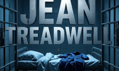 A viral, hyper-realistic YouTube thumbnail with a somber, cold-blue jail atmosphere. The background is a dimly lit concrete jail cell block with heavy shadows and faint emergency lighting. The composition uses a dramatic low-angle shot through rusted cell bars to focus on the main subject: a faceless empty jail cot with crumpled sheets and an abandoned inmate jumpsuit. The image features massive 3D typography with strict hierarchy: The Primary Text reads exactly: 'JEAN TREADWELL'. This text is massive, the largest element in the frame, rendered in cold brushed steel with subtle frost effect to look like a high-budget 3D render. The Secondary Text reads exactly: 'DEAD IN CELL'. This text is significantly smaller, positioned below the main text with a bold red outline border and glowing crimson edge effect. The text materials correspond to the story's concept. Crucial Instruction: There is absolutely NO other text, numbers, watermarks, or subtitles in this image other than these two specific lines. 8k, Unreal Engine 5, cinematic render