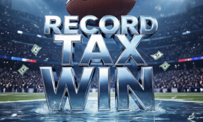 A viral, hyper-realistic YouTube thumbnail with a kinetic sports atmosphere. The background is a packed NFL stadium at night with dramatic floodlights cutting through light snow and roaring blurred crowds. The composition uses a low angle to focus on the main subject: a massive chrome football floating above a crystal-clear Colorado mountain river with cash bills transforming into water droplets mid-air. The image features massive 3D typography with strict hierarchy: The Primary Text reads exactly: 'RECORD TAX WIN'. This text is massive, the largest element in the frame, rendered in liquid chrome with rippling water reflections to look like a high-budget 3D render. The Secondary Text reads exactly: 'Colorado Betting Funds Water'. This text is significantly smaller, positioned below the main text. It features a thick electric-blue glowing outline with subtle snow particle effects to contrast against the background. Make sure text 2 is always different theme, style, effect and border compared to text 1. The text materials correspond to the story's concept. Crucial Instruction: There is absolutely NO other text, numbers, watermarks, or subtitles in this image other than these two specific lines. 8k, Unreal Engine 5, cinematic render