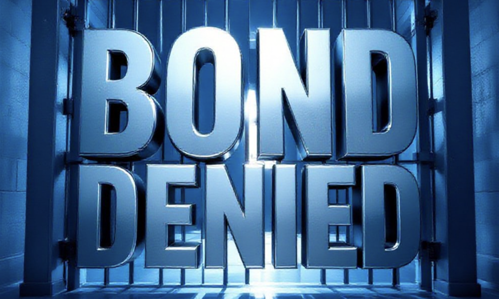 A viral, hyper-realistic YouTube thumbnail with a dramatic political atmosphere. The background is a cold Colorado courthouse hallway at dusk with harsh blue lighting and long shadows. The composition uses a low-angle shot to focus on the main subject: a massive steel prison door slamming shut. The image features massive 3D typography with strict hierarchy: The Primary Text reads exactly: 'BOND DENIED'. This text is massive, the largest element in the frame, rendered in cold chrome metal with sharp edges and realistic reflections. The Secondary Text reads exactly: 'Tina Peters Stays Locked Up'. This text is significantly smaller, positioned below the main text with a bold red outline and slight glow effect to stand out. The text materials correspond to the story's concept. Crucial Instruction: There is absolutely NO other text, numbers, watermarks, or subtitles in this image other than these two specific lines. 8k, Unreal Engine 5, cinematic render.