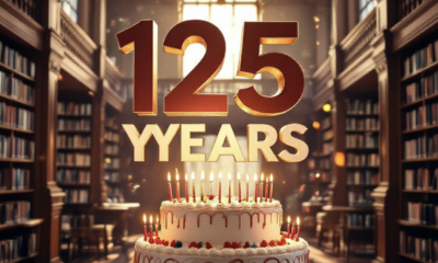 A viral, hyper-realistic YouTube thumbnail with a warm, nostalgic community celebration atmosphere. The background is the sunlit interior of the Grand Junction Central Library with towering wooden bookshelves filled with colorful books, soft golden hour light streaming through tall windows, and subtle confetti in the air. The composition uses a dramatic low-angle shot to focus on the main subject: a massive, beautifully frosted three-layer birthday cake on a library table with "125" candles glowing. The image features massive 3D typography with strict hierarchy: The Primary Text reads exactly: '125 YEARS'. This text is massive, the largest element in the frame, rendered in elegant gold chrome with subtle sparkles to look like a high-budget 3D render. The Secondary Text reads exactly: 'Mesa County Libraries'. This text is significantly smaller, positioned below the main text. It features a thick white outline with soft red sticker-style border to pop against the warm background. The text materials correspond to the story's concept. Crucial Instruction: There is absolutely NO other text, numbers, watermarks, or subtitles in this image other than these two specific lines. 8k, Unreal Engine 5, cinematic render