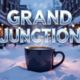 A viral, hyper-realistic YouTube thumbnail with a cozy winter blizzard atmosphere. The background is downtown Grand Junction buried in fresh white snow at golden hour with warm coffee shop windows glowing from inside. The composition uses a low-angle cinematic shot to focus on the main subject: a steaming oversized coffee mug placed prominently in thick snow with visible heat waves rising. The image features massive 3D typography with strict hierarchy: The Primary Text reads exactly: 'GRAND JUNCTION'. This text is massive, the largest element in the frame, rendered in icy blue chrome with frosty condensation effects to look like a high-budget 3D render. The Secondary Text reads exactly: 'RECORD SNOW'. This text is significantly smaller, positioned below the main text with a bold red sticker-style outline and subtle falling snow particles over it. The text materials correspond to the story's concept. Crucial Instruction: There is absolutely NO other text, numbers, watermarks, or subtitles in this image other than these two specific lines. 8k, Unreal Engine 5, cinematic render.