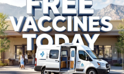 A viral, hyper-realistic YouTube thumbnail with a hopeful community health atmosphere. The background is a sunny Western Colorado street scene with subtle mountain outlines and warm inviting lighting. The composition uses a low angle to focus on the main subject: a detailed faceless mobile health clinic van parked at a community center with open doors and health symbols. The image features massive 3D typography with strict hierarchy: The Primary Text reads exactly: 'Free Vaccines Today'. This text is massive, the largest element in the frame, rendered in clean white chrome with blue accents to look like a high-budget 3D render. The Secondary Text reads exactly: 'Grand Junction Mobile Clinic'. This text is significantly smaller, positioned below the main text. It features a thick, distinct orange border/outline (sticker style) to contrast against the background. Make sure text 2 is always different theme, style, effect and border compared to text 1.