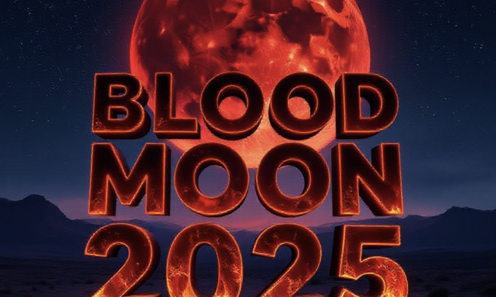 A viral, hyper-realistic YouTube thumbnail with a dramatic cosmic atmosphere. The background is a vast starry night sky over a dark desert landscape with distant mountains, illuminated by intense crimson moonlight. The composition uses a low-angle shot looking up to focus on the main subject: a massive, perfectly round blood-red moon dominating the sky. The image features massive 3D typography with strict hierarchy: The Primary Text reads exactly: 'BLOOD MOON 2025'. This text is massive, the largest element in the frame, rendered in glowing molten lava material with realistic 3D depth and ember particles to look like a high-budget cinematic render. The Secondary Text reads exactly: 'LONGEST ECLIPSE OF THE DECADE'. This text is significantly smaller, positioned below the main text with a thick neon-blue electric outline and subtle lightning crackle effect to contrast against the red background. Make sure text 2 is always different theme, style, effect and border compared to text 1. The text materials correspond to the story's concept. Crucial Instruction: There is absolutely NO other text, numbers, watermarks, or subtitles in this image other than these two specific lines. 8k, Unreal Engine 5, cinematic render