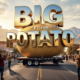 A viral, hyper-realistic YouTube thumbnail with a fun Western American atmosphere. The background is a sunny Colorado street with Grand Junction mountains in the distance and excited people taking photos, warm golden hour lighting. The composition uses a dramatic low angle to focus on the main subject: a massive 28-foot fiberglass Idaho potato on a flatbed truck. Image size should be 3:2. The image features massive 3D typography with strict hierarchy: The Primary Text reads exactly: 'BIG IDAHO POTATO'. This text is massive, the largest element in the frame, rendered in shiny chrome metallic to look like a high-budget 3D render. The Secondary Text reads exactly: 'INVADES GRAND JUNCTION'. This text is significantly smaller, positioned below the main text. It features a thick, bright yellow border/outline (sticker style) to contrast against the background. Make sure text 2 is always different theme, style, effect and border compared to text 1.