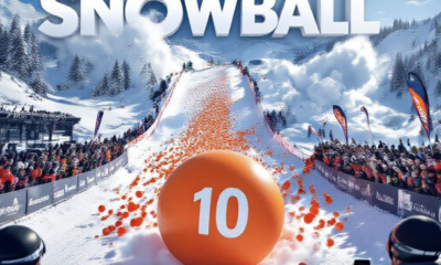 A viral, hyper-realistic YouTube thumbnail with a high-energy winter sports atmosphere. The background is a sun-drenched Powderhorn Mountain Resort slope packed with excited spectators as thousands of bright orange balls cascade down the snow in a massive colorful avalanche with dramatic powder clouds. The composition uses a dramatic low-angle shot from the finish line looking uphill to focus on the main subject: a giant, perfectly spherical numbered orange foam ball leading the charge. Image size should be 3:2. The image features massive 3D typography with strict hierarchy: The Primary Text reads exactly: '10TH SNOWBALL'. This text is massive, the largest element in the frame, rendered in icy chrome with frost and snow particles to look like a high-budget 3D render. The Secondary Text reads exactly: 'RECORD $42K'. This text is significantly smaller, positioned below the main text. It features a thick, glowing red border/outline (sticker style) to contrast against the background. Make sure text 2 is always different theme, style, effect and border compared to text 1.