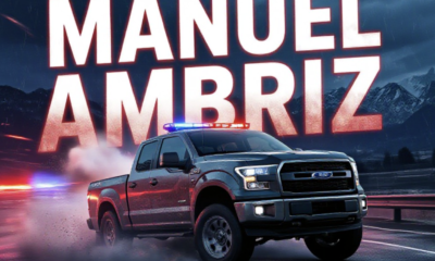 A viral, hyper-realistic YouTube thumbnail with a intense police chase atmosphere. The background is a dark Colorado night highway with blurred red and blue emergency lights streaking across wet pavement and distant Grand Valley mountains under stormy skies. The composition uses a dramatic low-angle shot to focus on the main subject: a battered stolen pickup truck sliding sideways with smoke pouring from tires. Image size should be 3:2. The image features massive 3D typography with strict hierarchy: The Primary Text reads exactly: 'MANUEL AMBRIZ'. This text is massive, the largest element in the frame, rendered in glowing red chrome with realistic bullet-hole damage and sparks flying off the letters to look like a high-budget 3D render. The Secondary Text reads exactly: 'GUN THREAT & WILD CHASE'. This text is significantly smaller, positioned below the main text. It features a thick white outline with pulsing blue police-light glow effect to contrast against the background. Make sure text 2 is always different theme, style, effect and border compared to text 1