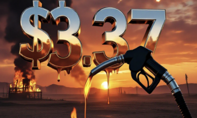 A viral, hyper-realistic YouTube thumbnail with a dramatic war-torn desert atmosphere. The background is a burning oil field at dusk with black smoke billowing into an orange sky and distant missile trails. The composition uses a low-angle cinematic shot to focus on the main subject: a close-up gas pump nozzle dripping fuel with flames reflecting in the chrome. Image size should be 3:2. The image features massive 3D typography with strict hierarchy: The Primary Text reads exactly: '$3.37'. This text is massive, the largest element in the frame, rendered in molten liquid metal with glowing embers and dripping effect to look like a high-budget 3D render. The Secondary Text reads exactly: 'Mesa County Surge'. This text is significantly smaller, positioned below the main text. It features a thick, neon-red glowing border/outline (sticker style) to contrast against the background. Make sure text 2 is always different theme, style, effect and border compared to text 1. The text materials correspond to the story's concept. Crucial Instruction: There is absolutely NO other text, numbers, watermarks, or subtitles in this image other than these two specific lines. 8k, Unreal Engine 5, cinematic render