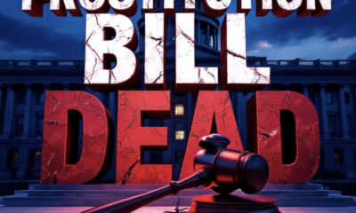 A viral, hyper-realistic YouTube thumbnail with a dramatic political atmosphere. The background is the Colorado State Capitol dome at dusk with deep red and blue lighting casting long shadows. The composition uses a low dramatic camera angle to focus on the main subject: a massive cracked gavel made of cold stone lying broken on marble steps. Image size should be 3:2. The image features massive 3D typography with strict hierarchy: The Primary Text reads exactly: 'PROSTITUTION BILL DEAD'. This text is massive, the largest element in the frame, rendered in cracked blood-red marble with deep shadows to look like a high-budget 3D render. The Secondary Text reads exactly: 'Colorado Postpones Indefinitely'. This text is significantly smaller, positioned below the main text. It features a thick white glow border with electric blue outline to contrast against the dark background. Make sure text 2 is always different theme, style, effect and border compared to text 1.