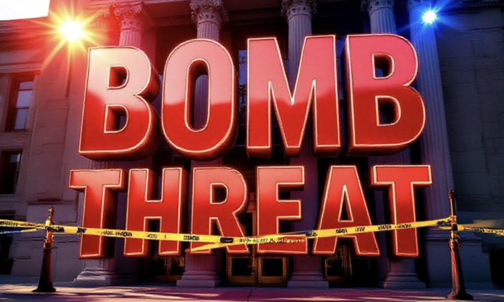 A viral, hyper-realistic YouTube thumbnail with a tense crime-scene atmosphere. The background is the Dennis Maes Judicial Building in Pueblo under harsh afternoon sunlight with red and blue emergency lights flashing across the facade. The composition uses a dramatic low angle to focus on the main subject: a large abandoned courthouse entrance with yellow police tape stretched across the doors. Image size should be 3:2. The image features massive 3D typography with strict hierarchy: The Primary Text reads exactly: 'BOMB THREAT'. This text is massive, the largest element in the frame, rendered in glowing red chrome to look like a high-budget 3D render. The Secondary Text reads exactly: 'Pueblo Courthouse Evacuated'. This text is significantly smaller, positioned below the main text. It features a thick white border with black outline (sticker style) to contrast against the background. Make sure text 2 is always different theme, style, effect and border compared to text 1.
