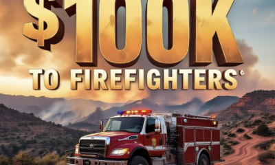 A viral, hyper-realistic YouTube thumbnail with a dramatic Western wildfire atmosphere. The background is a rugged Mesa County landscape at golden hour with smoke rising from distant ridges and red dirt roads winding through pinon-juniper. The composition uses a low-angle cinematic shot to focus on the main subject: a battle-worn wildland fire engine parked on a ridge with lights flashing. Image size should be 3:2. The image features massive 3D typography with strict hierarchy: The Primary Text reads exactly: '$100K TO FIREFIGHTERS'. This text is massive, the largest element in the frame, rendered in molten orange chrome with glowing embers and heat distortion to look like a high-budget 3D render. The Secondary Text reads exactly: 'MESA COUNTY STEPS UP'. This text is significantly smaller, positioned below the main text. It features a thick white border with red outline (sticker style) to contrast against the smoky sky. Make sure text 2 is always different theme, style, effect and border compared to text 1.