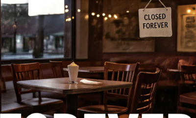 A viral, hyper-realistic YouTube thumbnail with a warm small-town American restaurant atmosphere. The background is the darkened interior of a beloved local bistro at closing time with empty tables and chairs pushed in, soft string lights still glowing, a handwritten "Closed Forever" sign on the door. The composition uses a low-angle shot through the window from outside to focus on the main subject: a single empty wooden chair pulled up to a table with a half-finished milkshake and a tip left behind. Image size should be 3:2. The image features massive 3D typography with strict hierarchy: The Primary Text reads exactly: 'FUNKY BEAR GONE'. This text is massive, the largest element in the frame, rendered in weathered neon tubing style with some bulbs flickering out to look like a high-budget 3D render. The Secondary Text reads exactly: 'Community Says Goodbye'. This text is significantly smaller, positioned below the main text. It features a thick white chalk-style border to contrast against the dark background. Make sure text 2 is always different theme, style, effect and border compared to text 1. The text materials correspond to the story's concept. Crucial Instruction: There is absolutely NO other text, numbers, watermarks, or subtitles in this image other than these two specific lines. 8k, Unreal Engine 5, cinematic render
