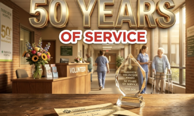 A viral, hyper-realistic YouTube thumbnail with a warm, golden-hour hospital atmosphere. The background is a softly lit Parkview hospital corridor filled with gentle sunlight streaming through windows and fresh flowers on the volunteer desk. The composition uses a low-angle cinematic shot to focus on the main subject: a beautifully crafted crystal volunteer award trophy resting on a wooden table beside a yellowed 1975 application paper. Image size should be 3:2. The image features massive 3D typography with strict hierarchy: The Primary Text reads exactly: '50 YEARS'. This text is massive, the largest element in the frame, rendered in polished gold chrome with subtle glowing edges to look like a high-budget 3D render. The Secondary Text reads exactly: 'OF SERVICE'. This text is significantly smaller, positioned below the main text. It features a thick white border with soft red outline (sticker style) to contrast against the warm background. Make sure text 2 is always different theme, style, effect and border compared to text 1
