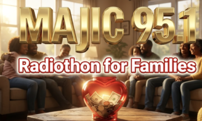 A viral, hyper-realistic YouTube thumbnail with a warm, hopeful midwest community atmosphere. The background is the cozy living room of the Ronald McDonald House in Fort Wayne at golden hour, soft sunlight streaming through windows onto families hugging. The composition uses a low angle to focus on the main subject: a glowing red heart-shaped donation jar overflowing with cash and coins. Image size should be 3:2. The image features massive 3D typography with strict hierarchy: The Primary Text reads exactly: 'MAJIC 95.1'. This text is massive, the largest element in the frame, rendered in polished gold chrome to look like a high-budget 3D render. The Secondary Text reads exactly: 'Radiothon for Families'. This text is significantly smaller, positioned below the main text. It features a thick, white glow border with red outline to contrast against the background. Make sure text 2 is always different theme, style, effect and border compared to text 1. The text materials correspond to the story's concept. Crucial Instruction: There is absolutely NO other text, numbers, watermarks, or subtitles in this image other than these two specific lines. 8k, Unreal Engine 5, cinematic render.