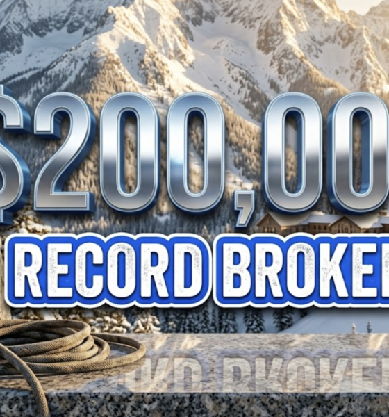 A viral, hyper-realistic YouTube thumbnail with a Kinetic Sports atmosphere. The background is a snowy, sun-drenched mountain campus in Gunnison with dramatic morning lighting. The composition uses a Low Angle to focus on the main subject: a Climbing Carabiner and Rope. Image size should be 3:2. The image features massive 3D typography with strict hierarchy: The Primary Text reads exactly: '$200,000'. This text is massive, the largest element in the frame, rendered in Chrome to look like a high-budget 3D render. The Secondary Text reads exactly: 'RECORD BROKEN'. This text is significantly smaller, positioned below or next to the main text. It features a thick, distinct color border/outline (sticker style) to contrast against the background. Make sure text 2 is always different theme, style, effect and border compared to text 1.