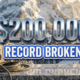 A viral, hyper-realistic YouTube thumbnail with a Kinetic Sports atmosphere. The background is a snowy, sun-drenched mountain campus in Gunnison with dramatic morning lighting. The composition uses a Low Angle to focus on the main subject: a Climbing Carabiner and Rope. Image size should be 3:2. The image features massive 3D typography with strict hierarchy: The Primary Text reads exactly: '$200,000'. This text is massive, the largest element in the frame, rendered in Chrome to look like a high-budget 3D render. The Secondary Text reads exactly: 'RECORD BROKEN'. This text is significantly smaller, positioned below or next to the main text. It features a thick, distinct color border/outline (sticker style) to contrast against the background. Make sure text 2 is always different theme, style, effect and border compared to text 1.