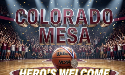 A viral, hyper-realistic YouTube thumbnail with a Sports kinetic energy atmosphere. The background is a packed college basketball arena bathed in deep maroon and white school colors with golden confetti frozen mid-air and dramatic spotlight beams cutting through arena haze. The composition uses a Low Angle shot to focus on the main subject: a gleaming NCAA basketball resting on center court with a runner-up medal draped over it, reflecting arena lights. Image size should be 3:2. The image features massive 3D typography with strict hierarchy: The Primary Text reads exactly: 'COLORADO MESA'. This text is massive, the largest element in the frame, rendered in polished chrome with maroon metallic accents to look like a high-budget 3D render. The Secondary Text reads exactly: 'HERO'S WELCOME'. This text is significantly smaller, positioned below the main text. It features a thick, glowing gold border and outline in a sticker style with a matte white fill to contrast against the dark arena background. The text materials correspond to the story's concept of triumph and community pride. Crucial Instruction: There is absolutely NO other text, numbers, watermarks, or subtitles in this image other than these two specific lines. 8k, Unreal Engine 5, cinematic rende