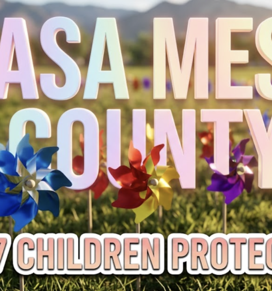 A viral, hyper-realistic YouTube thumbnail with a compassionate community activism atmosphere. The background is a sunny outdoor park setting in Colorado with mountains visible in the distance, natural daylight creating warm golden tones across green grass. The composition uses a low angle shot to focus on the main subject: a field of colorful spinning pinwheels planted in the ground, with blue, red, yellow, and purple pinwheels in sharp focus, their metallic centers catching sunlight while blurred rows extend into the background. Image size should be 3:2. The image features massive 3D typography with strict hierarchy: The Primary Text reads exactly: 'CASA MESA COUNTY'. This text is massive, the largest element in the frame, rendered in soft gradient pastel colors with gentle glow effect to look like a high-budget 3D render with compassionate warmth. The Secondary Text reads exactly: '237 CHILDREN PROTECTED'. This text is significantly smaller, positioned below the main text. It features a thick, distinct white border with inner shadow (sticker style) to contrast against the background. Make sure text 2 is always different theme, style, effect and border compared to text 1. The text materials correspond to the story's concept of hope and protection. Crucial Instruction: There is absolutely NO other text, numbers, watermarks, or subtitles in this image other than these two specific lines. 8k, Unreal Engine 5, cinematic render.