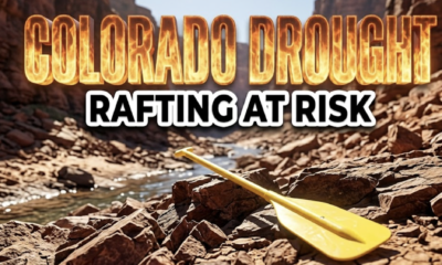 A viral, hyper-realistic YouTube thumbnail with a Kinetic atmosphere. The background is a sun-baked canyon riverbed with extremely low water levels with harsh midday sunlight. The composition uses a Low Angle to focus on the main subject: a bright yellow rubber rafting paddle resting on dry jagged rocks. Image size should be 3:2. The image features massive 3D typography with strict hierarchy: The Primary Text reads exactly: 'COLORADO DROUGHT'. This text is massive, the largest element in the frame, rendered in Orange and Yellow Fire to look like a high-budget 3D render. The Secondary Text reads exactly: 'RAFTING AT RISK'. This text is significantly smaller, positioned below or next to the main text. It features a thick, distinct black color border/outline (sticker style) to contrast against the background. Make sure text 2 is always different theme, style, effect and border compared to text 1. The text materials correspond to the story's concept. Crucial Instruction: There is absolutely NO other text, numbers, watermarks, or subtitles in this image other than these two specific lines. 8k, Unreal Engine 5, cinematic render