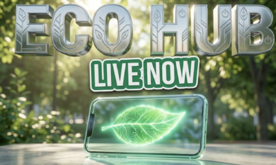 A viral, hyper-realistic YouTube thumbnail with a Sleek Tech atmosphere. The background is a vibrant city park with soft sunlight filtering through green leaves. The composition uses a Low Angle to focus on the main subject: a glowing transparent smartphone displaying a glowing green leaf. Image size should be 3:2. The image features massive 3D typography with strict hierarchy: The Primary Text reads exactly: 'ECO HUB'. This text is massive, the largest element in the frame, rendered in bright Chrome to look like a high-budget 3D render. The Secondary Text reads exactly: 'LIVE NOW'. This text is significantly smaller, positioned below or next to the main text. It features a thick, distinct color border/outline (sticker style) to contrast against the background. Make sure text 2 is always different theme, style, effect and border compared to text 1. The text materials correspond to the story's concept. Crucial Instruction: There is absolutely NO other text, numbers, watermarks, or subtitles in this image other than these two specific lines. 8k, Unreal Engine 5, cinematic render.