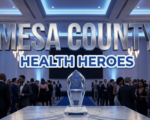 A viral, hyper-realistic YouTube thumbnail with a Sleek and Professional atmosphere. The background is a Modern Medical Gala Hall with Soft Blue and White Ambient Lighting. The composition uses a Low Angle to focus on the main subject: a Glass Crystal Health Award Trophy reflecting the lights. Image size should be 3:2. The image features massive 3D typography with strict hierarchy: The Primary Text reads exactly: 'MESA COUNTY'. This text is massive, the largest element in the frame, rendered in Chrome to look like a high-budget 3D render. The Secondary Text reads exactly: 'HEALTH HEROES'. This text is significantly smaller, positioned below the main text. It features a thick, distinct Blue sticker style border to contrast against the background. The text materials correspond to the story's concept. Crucial Instruction: There is absolutely NO other text, numbers, watermarks, or subtitles in this image other than these two specific lines. 8k, Unreal Engine 5, cinematic render.