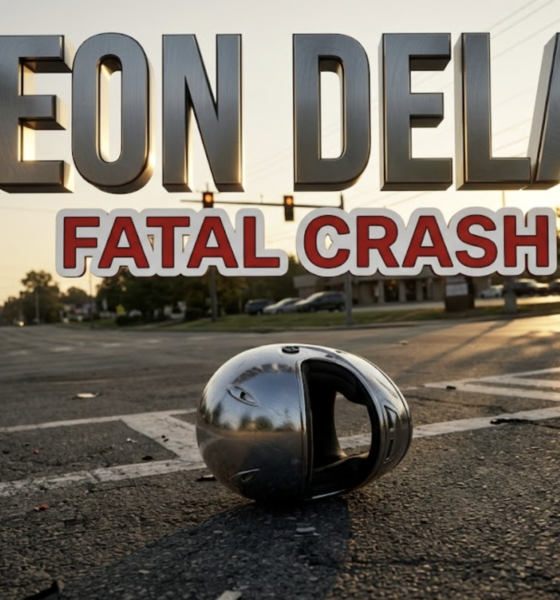 A viral, hyper-realistic news thumbnail with a somber, documentary-style atmosphere. The background is a suburban intersection at golden hour with traffic lights, road markings, and a distant parking lot entrance, bathed in soft, directional sunlight creating long shadows. The composition uses a low-angle Dutch tilt to create visual tension, focusing on the main subject: a chrome motorcycle helmet lying on asphalt with visible road texture and paint markings. Image size should be 3:2. The image features massive 3D typography with strict hierarchy: The Primary Text reads exactly: 'LEON DELAP'. This text is massive, the largest element in the frame, rendered in Brushed Steel with dramatic rim lighting to look like a high-budget 3D memorial render. The Secondary Text reads exactly: 'FATAL CRASH'. This text is significantly smaller, positioned below the main text. It features a thick, distinct red and white border/outline (sticker style) with a matte finish to contrast against the background. Make sure text 2 is always different theme, style, effect and border compared to text 1. The text materials correspond to the story's somber, memorial concept. Crucial Instruction: There is absolutely NO other text, numbers, watermarks, or subtitles in this image other than these two specific lines. 8k, Unreal Engine 5,