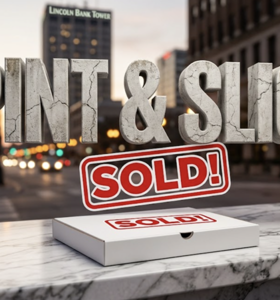 A viral, hyper-realistic YouTube thumbnail with a sophisticated business atmosphere. The background is a blurred, bustling city street at dusk in Fort Wayne, with bokeh lights and a subtle glow. The composition uses a low angle shot to focus on the main subject: a single, pristine white pizza box with a "SOLD" sign sticker on it, resting on a polished marble countertop. Image size should be 3:2. The image features massive 3D typography with strict hierarchy: The Primary Text reads exactly: 'PINT & SLICE'. This text is massive, the largest element in the frame, rendered in distressed, cracked concrete to look like a historic monument. The Secondary Text reads exactly: 'SOLD!'. This text is significantly smaller, positioned below the main text. It features a thick, vibrant red border/outline (sticker style) to contrast against the background.