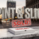 A viral, hyper-realistic YouTube thumbnail with a sophisticated business atmosphere. The background is a blurred, bustling city street at dusk in Fort Wayne, with bokeh lights and a subtle glow. The composition uses a low angle shot to focus on the main subject: a single, pristine white pizza box with a "SOLD" sign sticker on it, resting on a polished marble countertop. Image size should be 3:2. The image features massive 3D typography with strict hierarchy: The Primary Text reads exactly: 'PINT & SLICE'. This text is massive, the largest element in the frame, rendered in distressed, cracked concrete to look like a historic monument. The Secondary Text reads exactly: 'SOLD!'. This text is significantly smaller, positioned below the main text. It features a thick, vibrant red border/outline (sticker style) to contrast against the background.