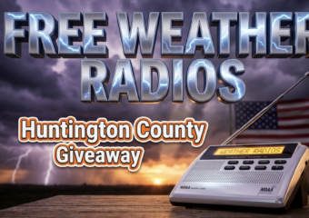 A viral, hyper-realistic YouTube thumbnail with a community safety and emergency preparedness atmosphere. The background is a dramatic Midwestern stormy sky with dark purple and gray clouds, lightning strikes in the distance, and a gradient of orange sunset breaking through on the horizon with volumetric god rays. The composition uses a low angle shot to focus on the main subject: a gleaming modern NOAA weather radio with extended antenna, LED display glowing bright amber, positioned on a wooden table with an American flag subtly visible in the background blur. Image size should be 3:2. The image features massive 3D typography with strict hierarchy: The Primary Text reads exactly: 'FREE WEATHER RADIOS'. This text is massive, the largest element in the frame, rendered in metallic chrome with electric blue lightning bolt effects crackling across the surface to look like a high-budget 3D render. The Secondary Text reads exactly: 'Huntington County Giveaway'. This text is significantly smaller, positioned below the main text. It features a thick, distinct orange and white border/outline in sticker style to contrast against the stormy background. Make sure text 2 is always different theme, style, effect and border compared to text 1. The text materials correspond to the story's concept. Crucial Instruction: There is absolutely NO other text, numbers, watermarks, or subtitles in this image other than these two specific lines. 8k, Unreal Engine 5, cinematic render.