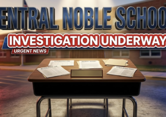 A viral, hyper-realistic YouTube thumbnail with a serious investigative news atmosphere. The background is a blurred Indiana school building exterior with dramatic golden hour lighting and police car lights creating red and blue ambient glows. The composition uses a low angle to focus on the main subject: a detailed wooden school desk with an empty nameplate and administrative documents scattered across it, symbolizing absence and investigation. The image features massive 3D typography with strict hierarchy: The Primary Text reads exactly: 'CENTRAL NOBLE SCHOOLS'. This text is massive, the largest element in the frame, rendered in polished dark blue metal with engraved texture to look like a high-budget 3D render. The Secondary Text reads exactly: 'INVESTIGATION UNDERWAY'. This text is significantly smaller, positioned below the main text. It features a thick, distinct red and white border/outline (sticker style) with a urgent news banner effect to contrast against the background. Make sure text 2 is always different theme, style, effect and border compared to text 1.